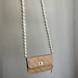 Small tan bag with pearl strap